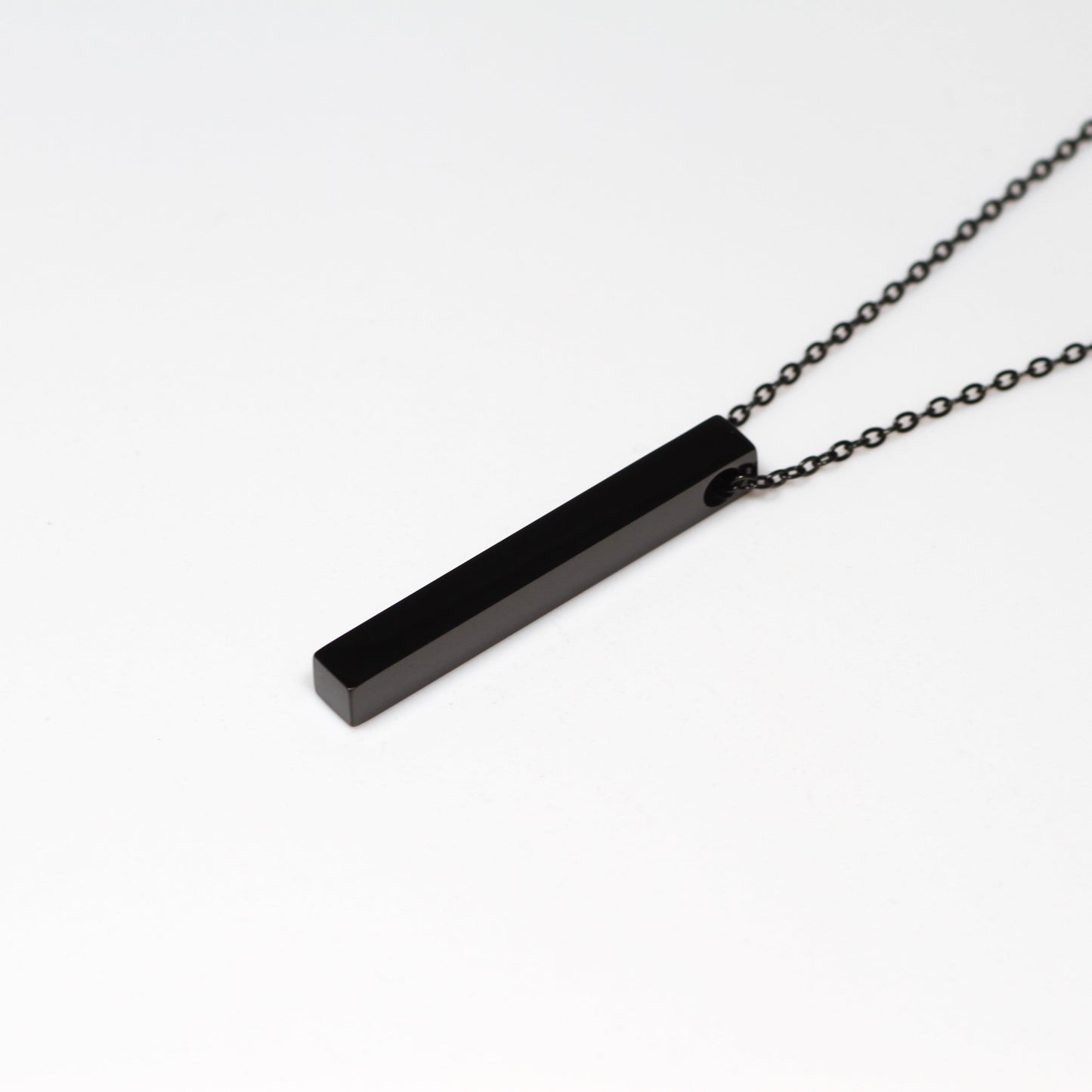 Black bar necklace on a white background