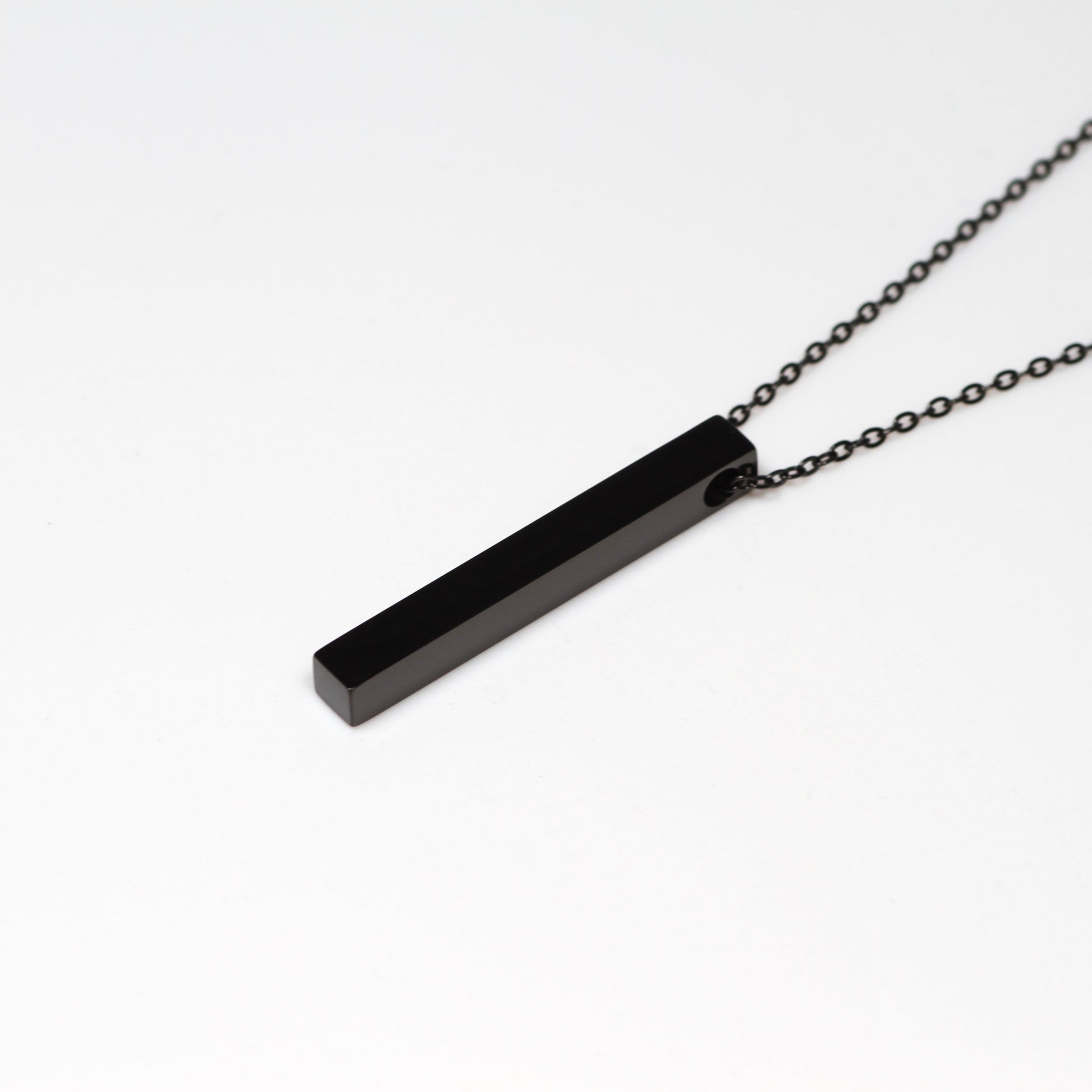 Black bar necklace on a white background