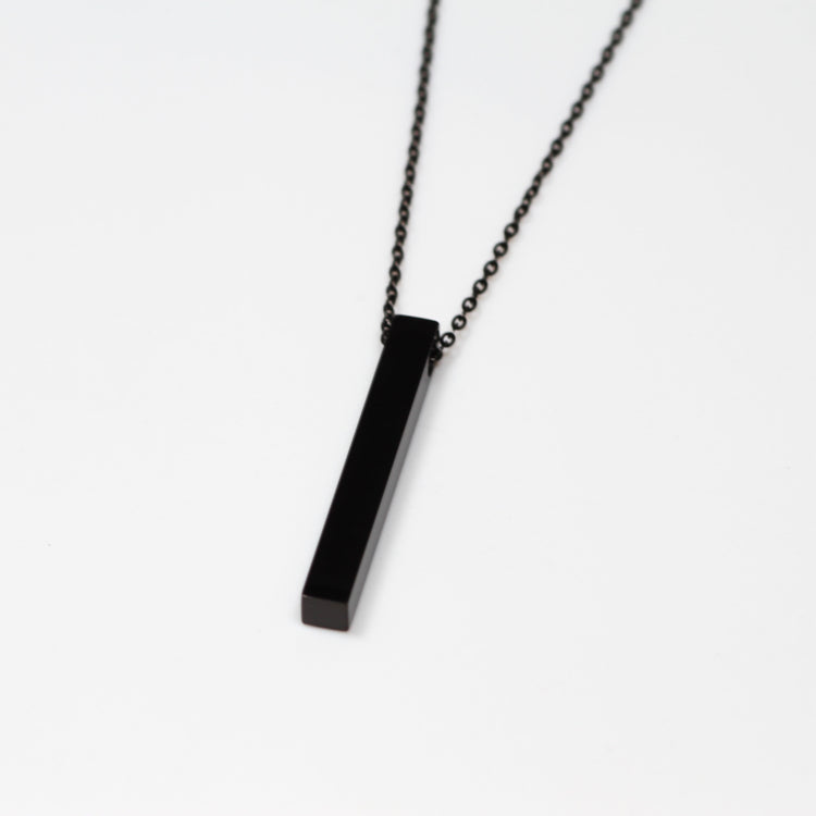 Black rectangular pendant on a chain against a white background