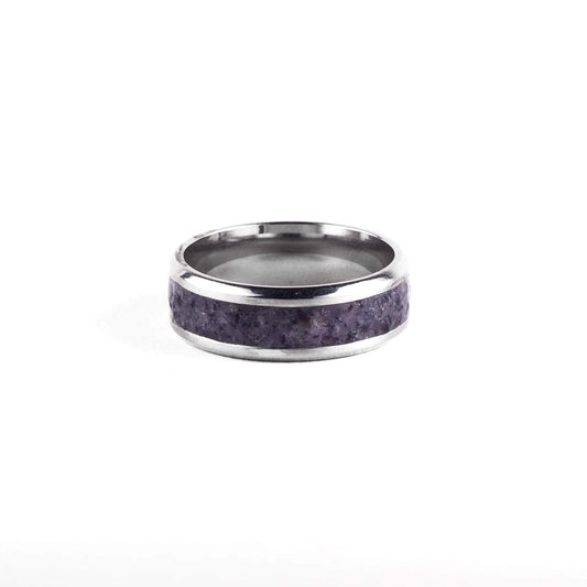 Silver ring with purple gemstone inlay on a white background