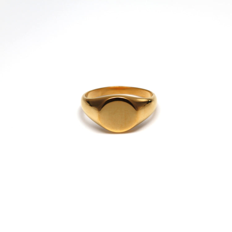 Gold ring signet ring on a white background