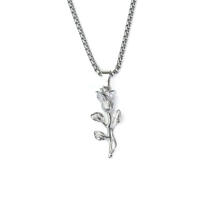 Silver necklace with a leaf-shaped pendant on a white background
