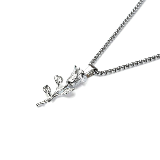 Silver necklace with a leaf-shaped pendant on a white background