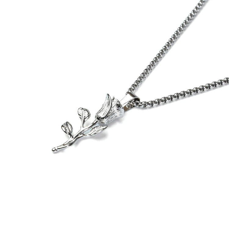 Silver necklace with a leaf-shaped pendant on a white background
