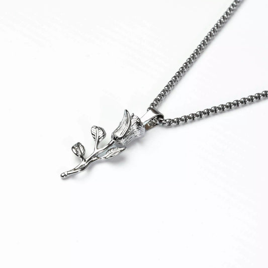 Silver necklace with a leaf-shaped pendant on a white background