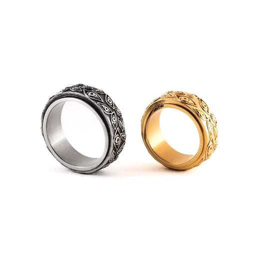 Two rings, one silver and one gold, on a white background