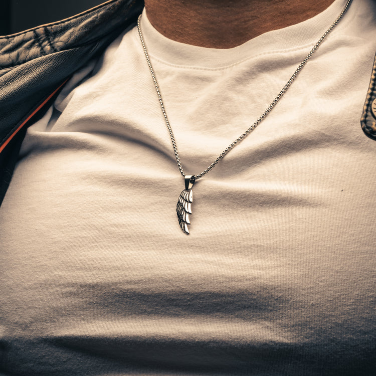 Male wearing a stainless steel wing pendant