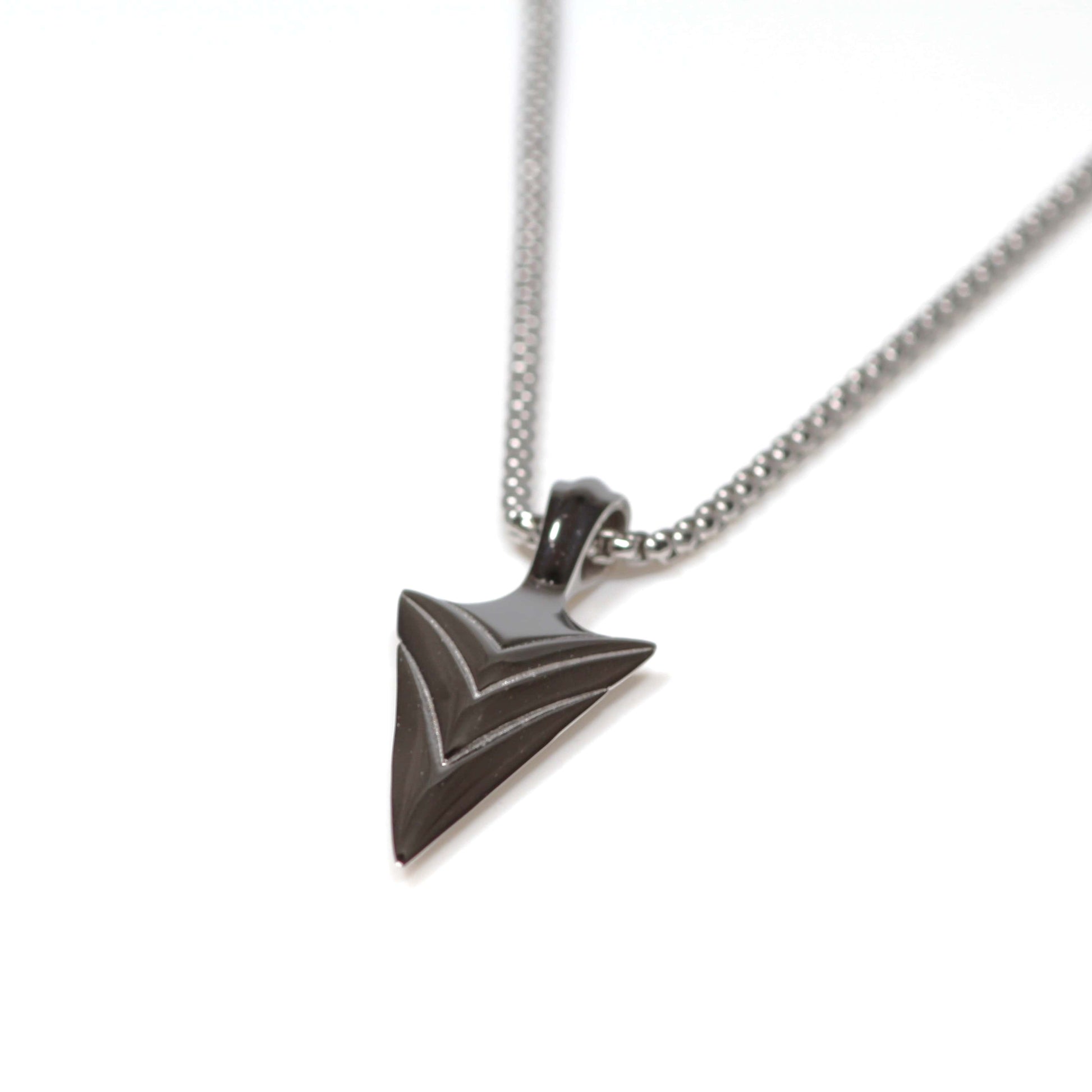 Silver necklace with a triangular pendant on a white background