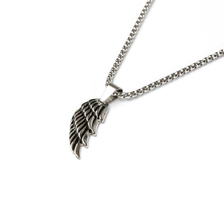 Close-up of water-resistant silver feather pendant, durable and stylish